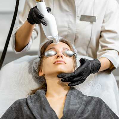 women getting laser treatment on her face