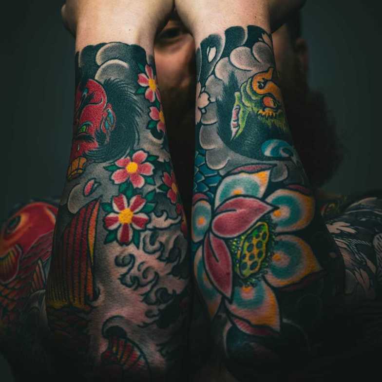 Person with colored tattoo on arms